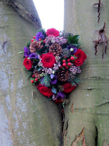 Winter shower wedding bouquet in red, purple and lilac with Berries, Pine Cones and Pine. Floral design by Cotswold Blooms, wedding florist based in Cheltenham.