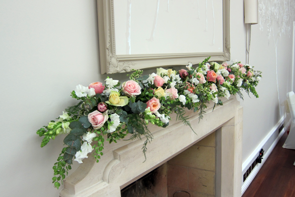Mantelpiece display at Foxhill Manor, Broadway. Floral design by Cotswold Blooms, wedding florist based in Cheltenham.