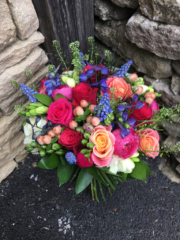 Bright bouquet in pink, blue and peach with foliage. Floral design by Cotswold Blooms, wedding florist based in Cheltenham.