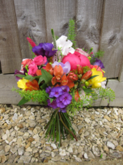 Bright hand tied bouquet with Phlox, Peonies, Freesia and Alstroemeria. Floral design by Cotswold Blooms, wedding florist based in Cheltenham.