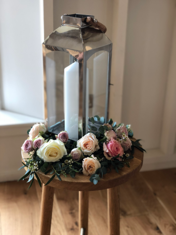 Lantern with flowers around the base. Floral design by Cotswold Blooms, wedding florist based in Cheltenham.