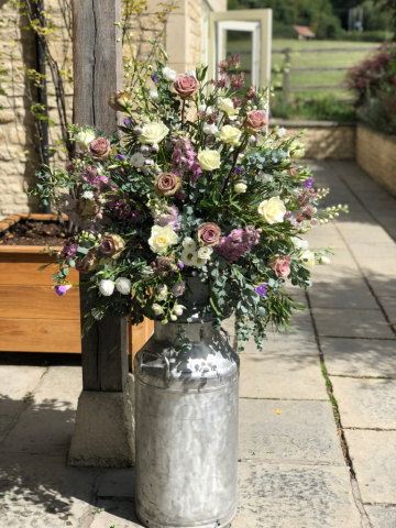 Dusky pink and white with touches of purple including Roses, Eustoma, Delphinium and Freesia. Floral design by Cotswold Blooms, wedding florist based in Cheltenham.