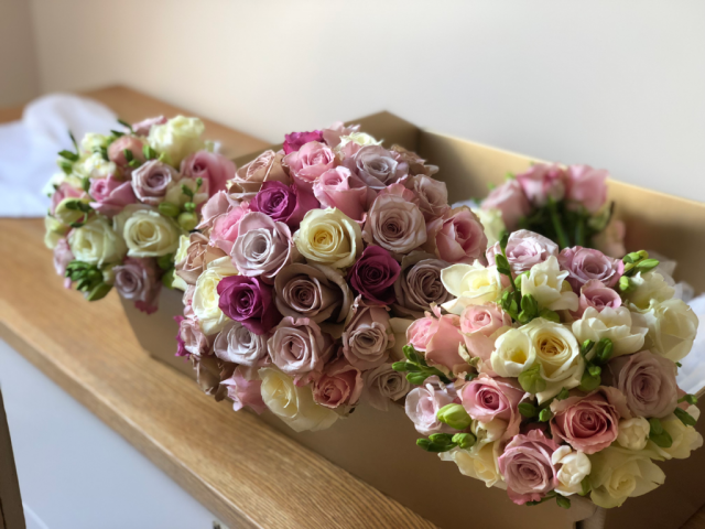 Mixed Rose brides bouquet with Rose and Freesia Bridesmaids bouquet. Floral design by Cotswold Blooms, wedding florist based in Cheltenham.