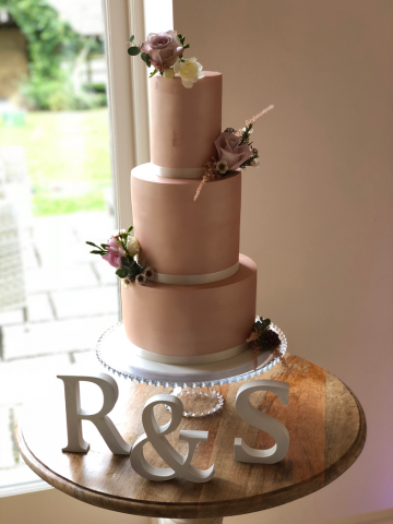 Copper cake with Roses, Wax Flower and Freesia. Floral design by Cotswold Blooms, wedding florist based in Cheltenham.