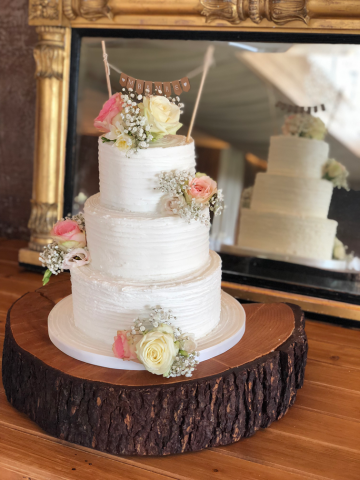 Cake with Roses and Gypsophila at Elmore Court. Floral design by Cotswold Blooms, wedding florist based in Cheltenham.