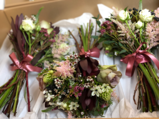 Bride and bridesmaids bouquets in burgundy, dusky pink and blue berries with Heather, Veronica and Safari. Floral design by Cotswold Blooms, wedding florist based in Cheltenham.