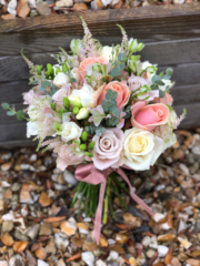 Domed hand tied bouquet in tones of peach, rose gold and cream. Floral design by Cotswold Blooms, wedding florist based in Cheltenham.