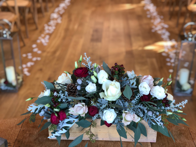 Winter wedding rustic box and petals down the aisle at the Grange, Hyde House, Stow-on-the-Wold. Floral design by Cotswold Blooms, wedding florist based in Cheltenham.