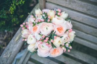 Peach, and cream bouquet with Roses, Hypericum, Tulips and Ranunculus. Floral design by Cotswold Blooms, wedding florist based in Cheltenham.