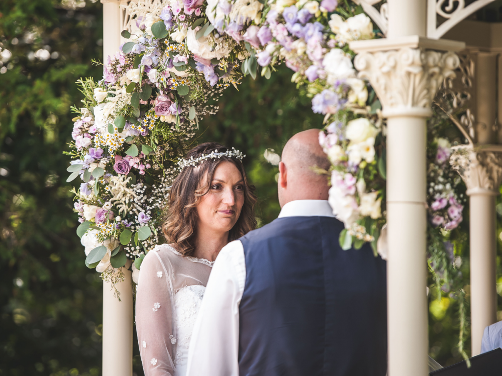 Country garden wedding arch with lilac and cream flowers at Manor by the Lake