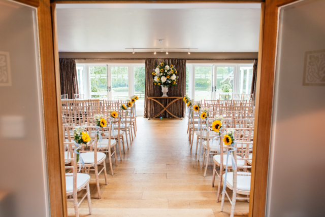 Wedding ceremony dressed with sunflowers and hydrangeas at Hyde House, Stow-on-the-Wold.  Floral design by Cotswold Blooms, wedding florist based in Cheltenham.