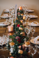 Foliage table runner with hypericum berries and ranunculus. Floral design by Cotswold Blooms, wedding florist based in Cheltenham.