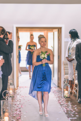 Bridesmaid bouquets and petals lining the isle with lanterns. Floral design by Cotswold Blooms, wedding florist based in Cheltenham.