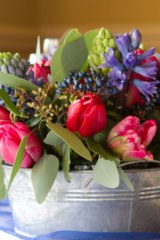 Vibrant table centre to follow a blue theme. Floral design by Cotswold Blooms, wedding florist based in Cheltenham.