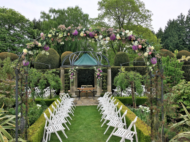Outdoor wedding ceremony at Birtsmorton Court.  Floral design by Cotswold Blooms, wedding florist based in Cheltenham.