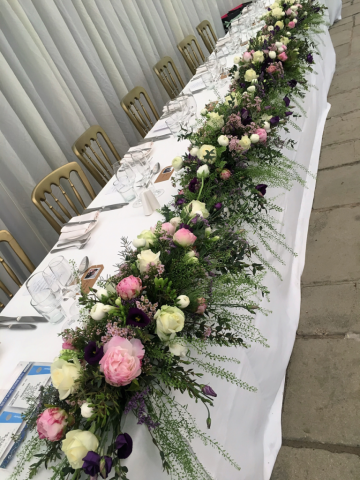 Peonies, Roses and Eustoma top table display, at Birtsmorton Court. Floral design by Cotswold Blooms, wedding florist based in Cheltenham.