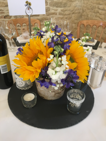 Sunflowers and Delphinium in a birch bowl. Floral design by Cotswold Blooms, wedding florist based in Cheltenham.