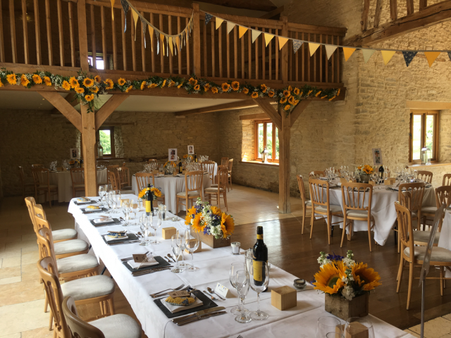 Kingscote Barn sunflower wedding. Floral design by Cotswold Blooms, wedding florist based in Cheltenham.