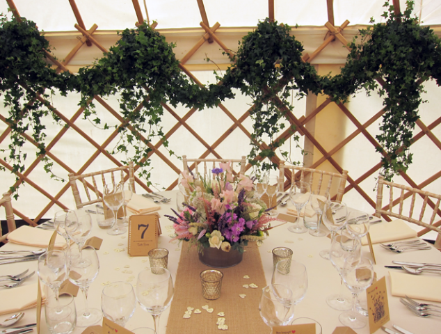Yurt wedding dressed with Ivy, and country garden table displays. Floral design by Cotswold Blooms, wedding florist based in Cheltenham.
