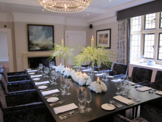 Singapore Orchid spray with Hydrangea and candles at Foxhill manor. Floral design by Cotswold Blooms, wedding florist based in Cheltenham.