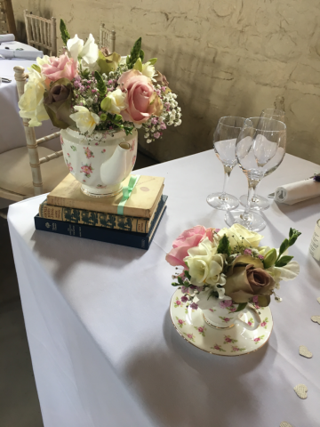 Cream, champagne and pink roses with Freesia and Gypsophila in a vintage tea set. Floral design by Cotswold Blooms, wedding florist based in Cheltenham.
