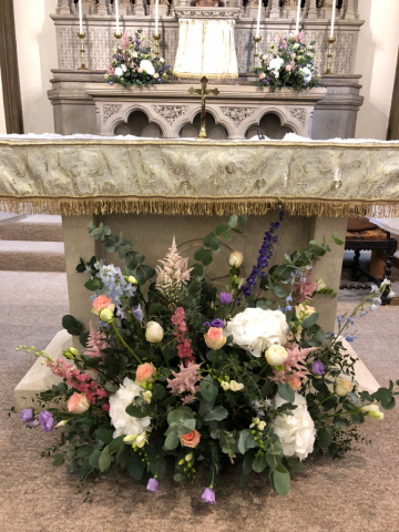 Delphinium, Peonies and Roses at St Peters Church, Cirencester. Floral design by Cotswold Blooms, wedding florist based in Cheltenham.