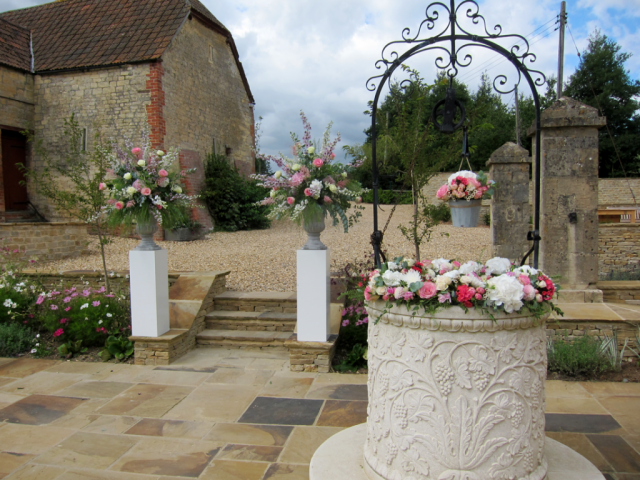 Outdoor ceremony in light pinks and whites. Floral design by Cotswold Blooms, wedding florist based in Cheltenham.