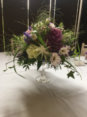 Vintage glass cake stand with a natural display or Brassica, Astilbe and Fountain Grass at The Barn at Upcote. Floral design by Cotswold Blooms, wedding florist based in Cheltenham.