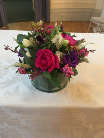 Hops, Wheat, Berries, mixed Foliage. Eustoma and Roses in a glass salad bowl. Floral design by Cotswold Blooms, wedding florist based in Cheltenham.
