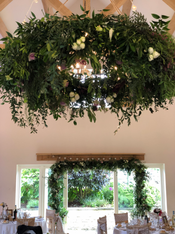Halo containing mix foliage and Roses at Hyde House, Stow-on-the-Wold.  Floral design by Cotswold Blooms, wedding florist based in Cheltenham.