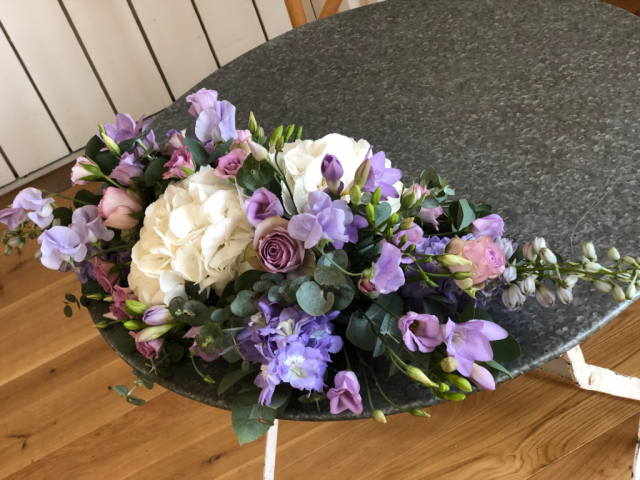 White Hydrangea, with lilac Delphinium, Sweetpeas and Freesia table display. Floral design by Cotswold Blooms, wedding florist based in Cheltenham.