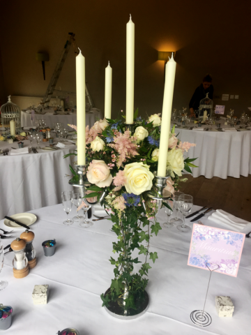Silver candelabra with a flower ball and trailing Ivy at Hyde House, Stow-on-the-Wold. Floral design by Cotswold Blooms, wedding florist based in Cheltenham.