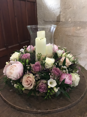 Hurricane lantern with Peonies, Roses and Waxflower in shades of pink. Floral design by Cotswold Blooms, wedding florist based in Cheltenham.