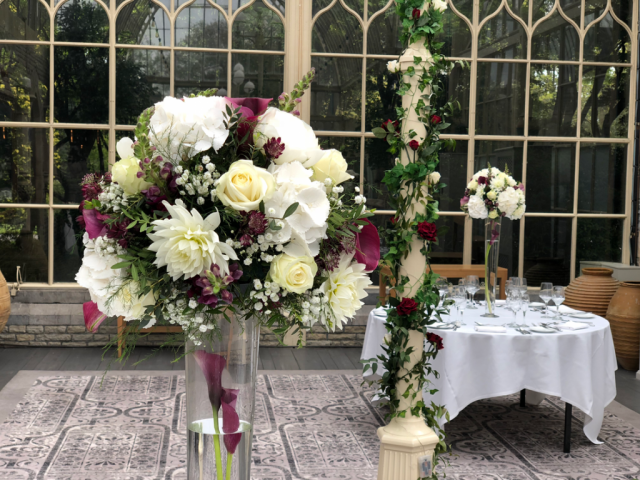 Burgundy and white Calla Lilies, Dahlias and Snapdragons at Tortworth Court. Floral design by Cotswold Blooms, wedding florist based in Cheltenham.