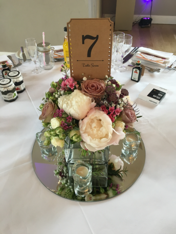 Peonies, Roses and Astrantia in a glass cube table centre arrangement. Floral design by Cotswold Blooms, wedding florist based in Cheltenham.