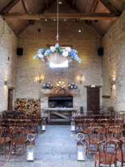 Umbrella flower displays and mantel piece at Cripps Barn, with blue Delphinium and pink Hydrangea. Floral design by Cotswold Blooms, wedding florist based in Cheltenham.