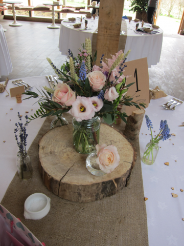 A country garden table display with dried crops at Cripps Barn. Floral design by Cotswold Blooms, wedding florist based in Cheltenham.