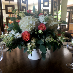 A cake stand display in white, coral and greens at Dormy House Hotel. Floral design by Cotswold Blooms, wedding florist based in Cheltenham.