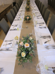 Juliet Roses with tanacetum in rustic wooden boxes at Thyme Hotel, Southrop. Floral design by Cotswold Blooms, wedding florist based in Cheltenham.