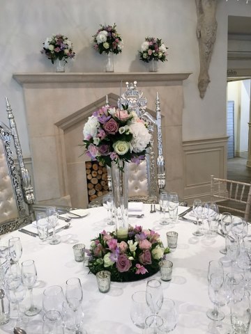 A lily vase and mantel display at Manor by the Lake, Cheltenham. Floral design by Cotswold Blooms, wedding florist based in Cheltenham.