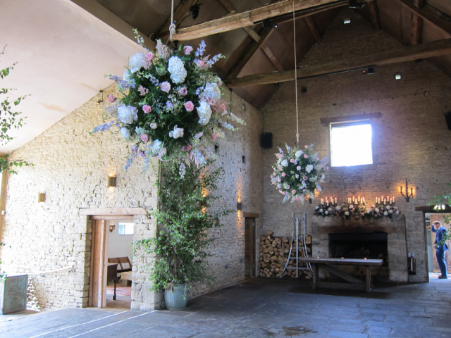 Dual flower balls and mantel piece display designed in light blue, pink and white at Cripps Barn.  Floral design by Cotswold Blooms, wedding florist based in Cheltenham.