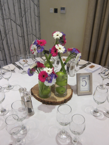 Pink and white Gerbera with purple Scabiosa and apples at The Manor House Hotel in Morton in the Marsh. Floral design by Cotswold Blooms, wedding florist based in Cheltenham.