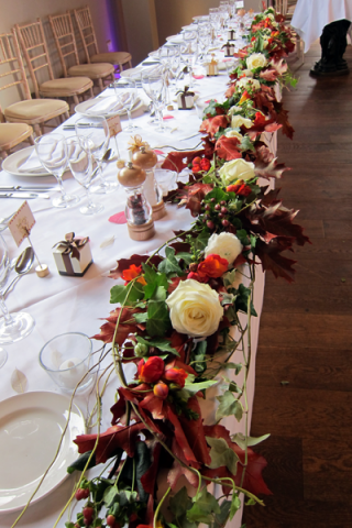 Top table display at Hyde House, using autumn foliage and seasonal flowers.  Floral design by Cotswold Blooms, wedding florist based in Cheltenham.