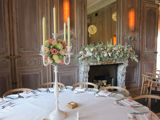 Mantel piece and candelabra display in light pinks and peaches at Cowley Manor. Floral design by Cotswold Blooms, wedding florist based in Cheltenham.