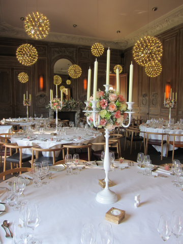 Candelabra and mantel piece display in peach, light pink and white at Cowley Manor. Floral design by Cotswold Blooms, wedding florist based in Cheltenham.