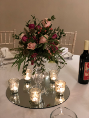 Textured display in raspberry and light pink tones with snow berries, seed pods and heather. Floral design by Cotswold Blooms, wedding florist based in Cheltenham.