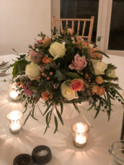 White cake stand with mixed foliage and Roses. Floral design by Cotswold Blooms, wedding florist based in Cheltenham.