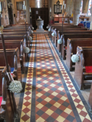 Gypsophila flower balls used to decorate isle markers at Lower Slaughter Church. Floral design by Cotswold Blooms, wedding florist based in Cheltenham.