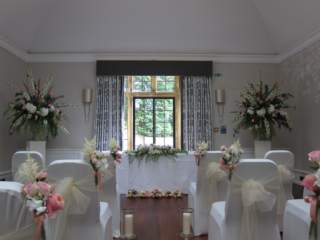 Pedestals, isle markers and registrars displays at Foxhill Manor. Floral design by Cotswold Blooms, wedding florist based in Cheltenham.