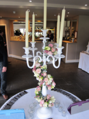 Candelabra display wrapped with Roses, Freesia and Wax Flower. Floral design by Cotswold Blooms, wedding florist based in Cheltenham.